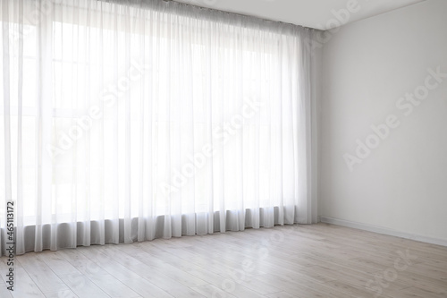 Slika na platnu Light curtains on big window in empty room