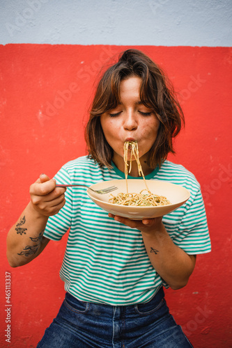 young woman eating pasta cute girl eating spaghetti having fun delicious food photography