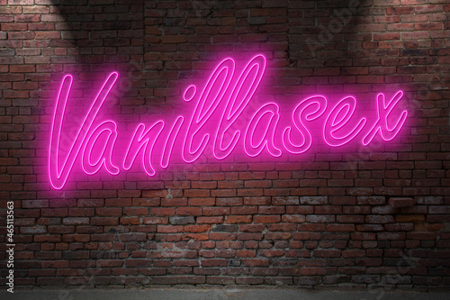 Neon Vanilla lettering on Brick Wall at night photo