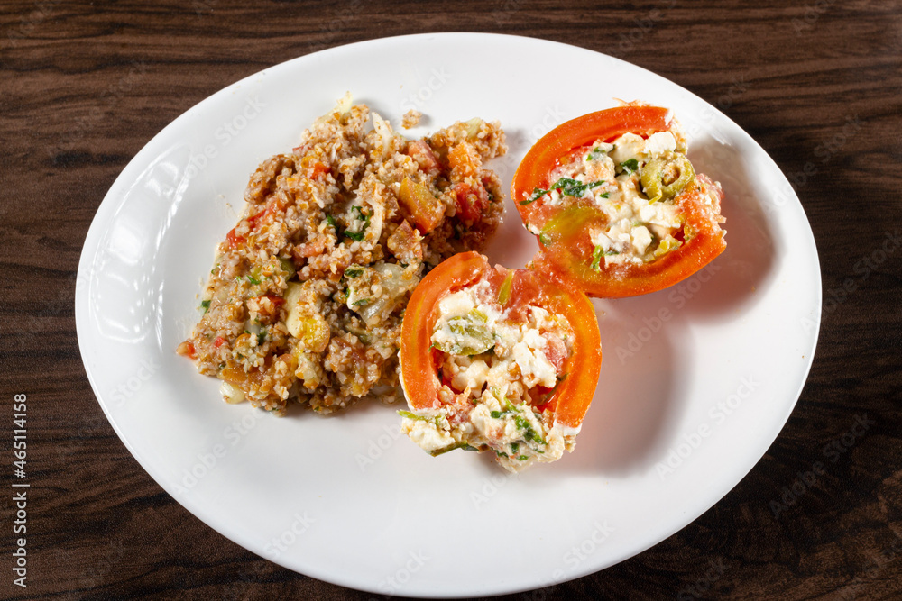 Tabbouleh Salad with stuffed tomato. Vegetarian food. Traditional middle eastern or Arab dish. Top view