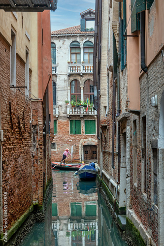 A gondolier crosses a canal in Venice