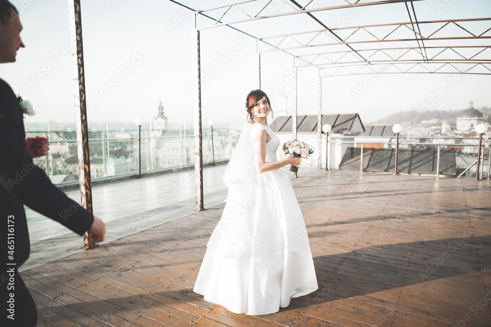 Obraz premium Gorgeous wedding couple walking in the old city of Lviv
