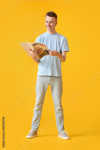 Young man reading magazine ...