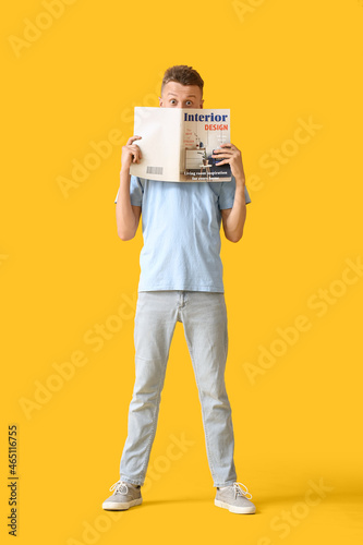 Young man reading magazine ...