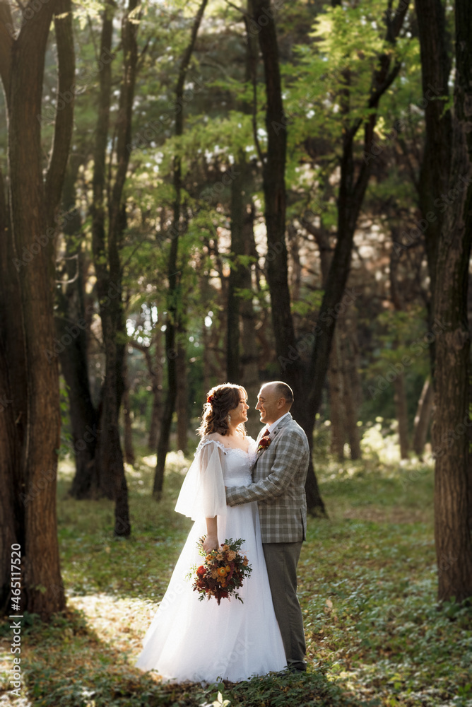 walk of the bride and groom through the autumn forest