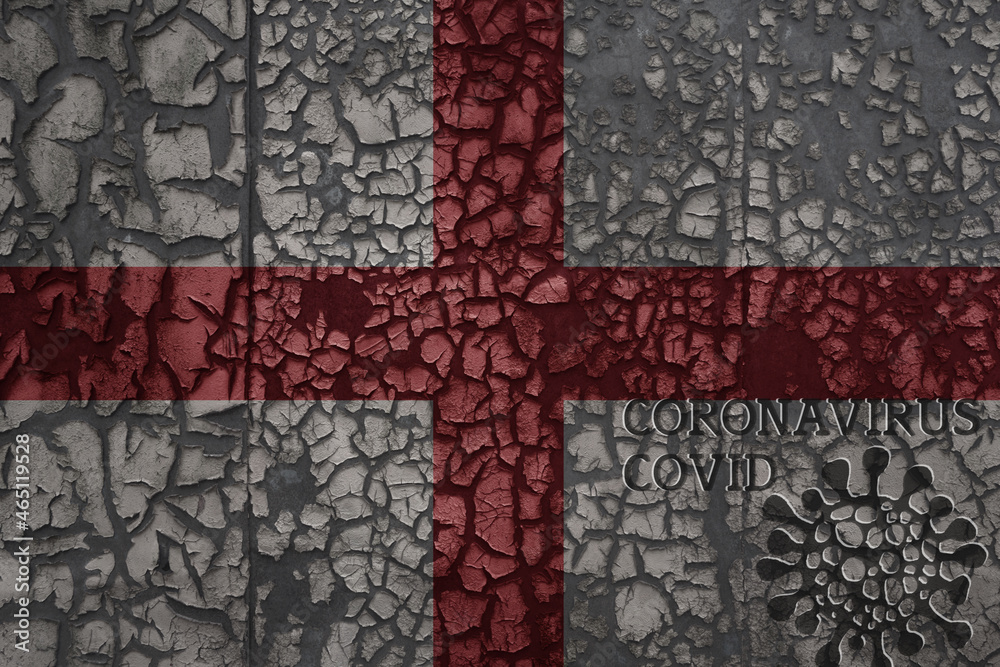 flag of england on a old metal rusty cracked wall with text coronavirus, covid, and virus picture.