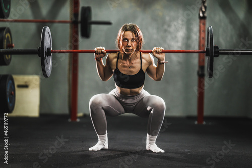 Woman Doing Squat Exercise At The Gym