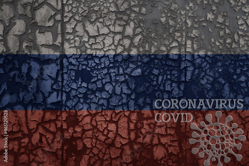 flag of russia on a old metal rusty cracked wall with text coronavirus, covid, and virus picture.