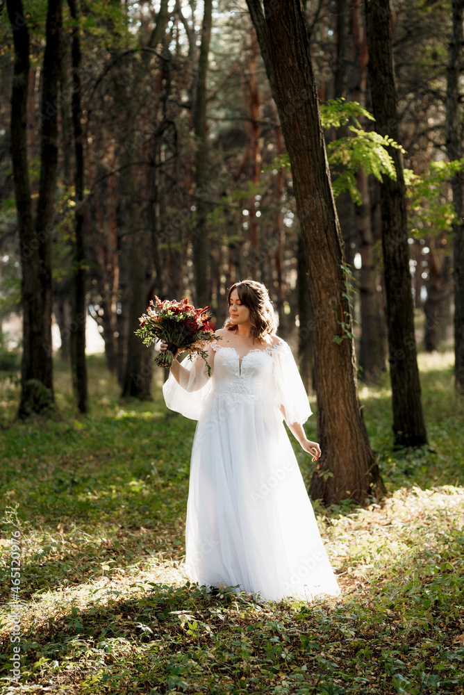 girl in a wedding dress in the autumn forest