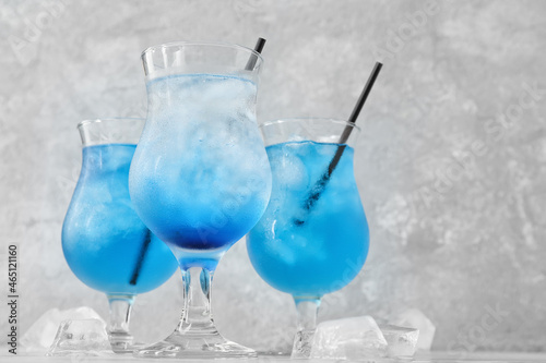 Glasses of Blue Lagoon cocktail on table, closeup
