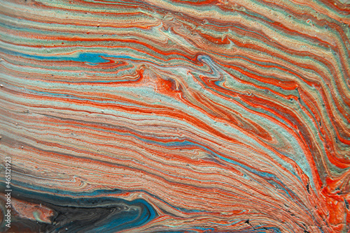 Texture in the style of fluid art. Abstract background with swirling paint effect. Liquid acrylic paint background. Blue, orange, gray and brick colors.