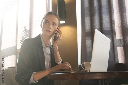 Girl freelancer working on a laptop in cafe. Work from home. Remote education