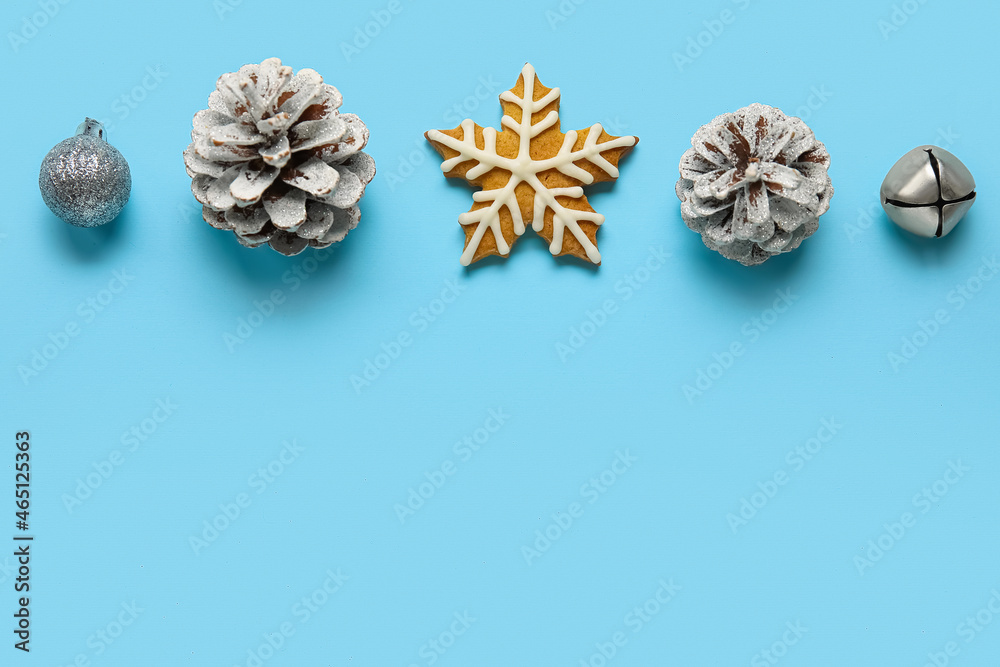 Tasty cookie and Christmas decorations on blue background Tasty cookie and Christmas decorations on blue background