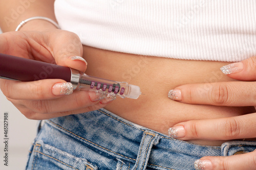 Woman doing insulin injection photo