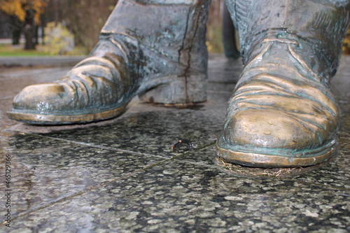 Bronze boots on the granite block