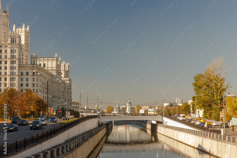 Moscow, Russia, Oct 07, 2021:  Sunny day in October. Astakhovsky bridge over Yauza river. Soviet skyscraper in left side
