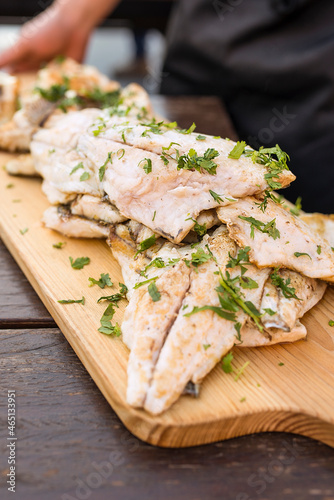 fish fillets with herbs on a wood table