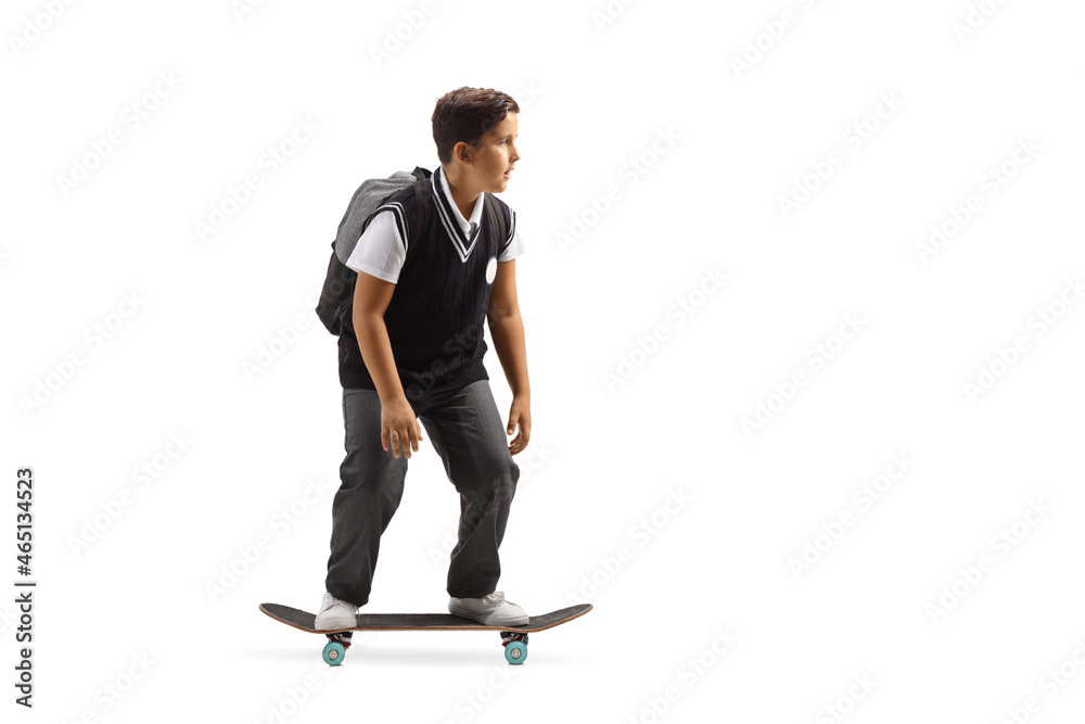 Full length shot of a schoolboy in a uniform riding a skateboard Full length shot of a schoolboy in a uniform riding a skateboard