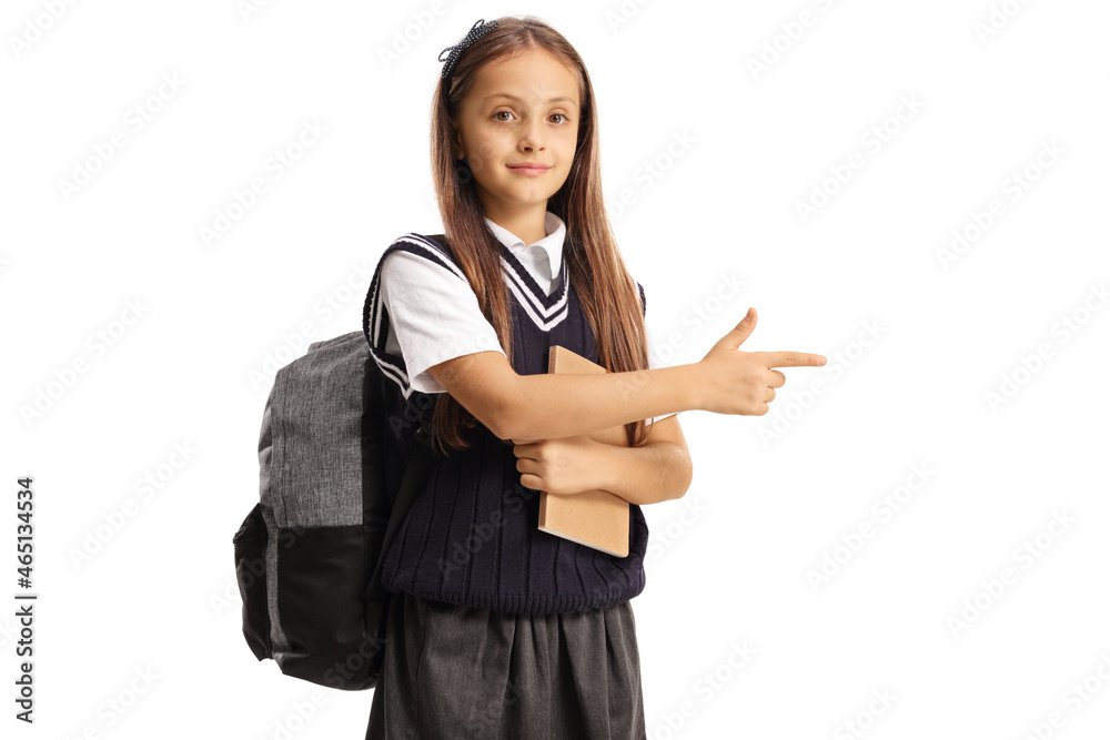 Schoolgirl with a backpack holding a book and pointing Schoolgirl with a backpack holding a book and pointing