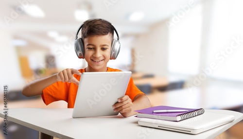 Little child taking class online and happy for Homeschool Quarantine coranavirus pandemic concept photo