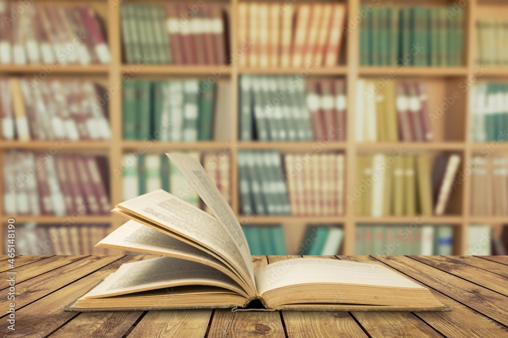 Open book on old wooden table in the library Open book on old wooden table in the library