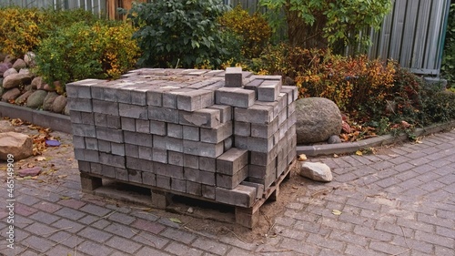 Construction Site with Paving Bricks Stacked on Wooden Standardized Transport Pallet