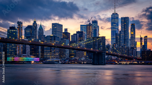New York skyline view with Brooklyn bridge at sunset © Alexander