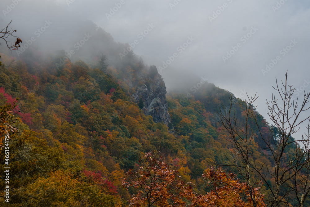 A colorful Autumn view of the Mount Tammany, Delaware Water Gap, with rocks and cloud on the top A colorful Autumn view of the Mount Tammany, Delaware Water Gap, with rocks and cloud on the top