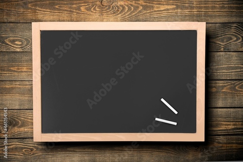 blank green chalkboard on a wall, school and teaching concept,