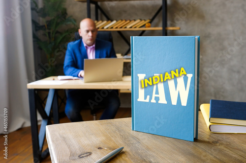 Lawyer holds INDIANA LAW book. Indiana residents are subject to Indiana state and U.S. federal laws photo