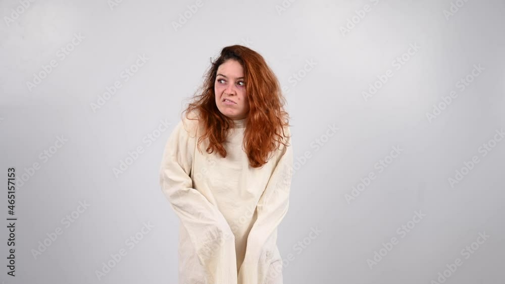 Close-up portrait of insane woman in straitjacket on white background. Close-up portrait of insane woman in straitjacket on white background.
