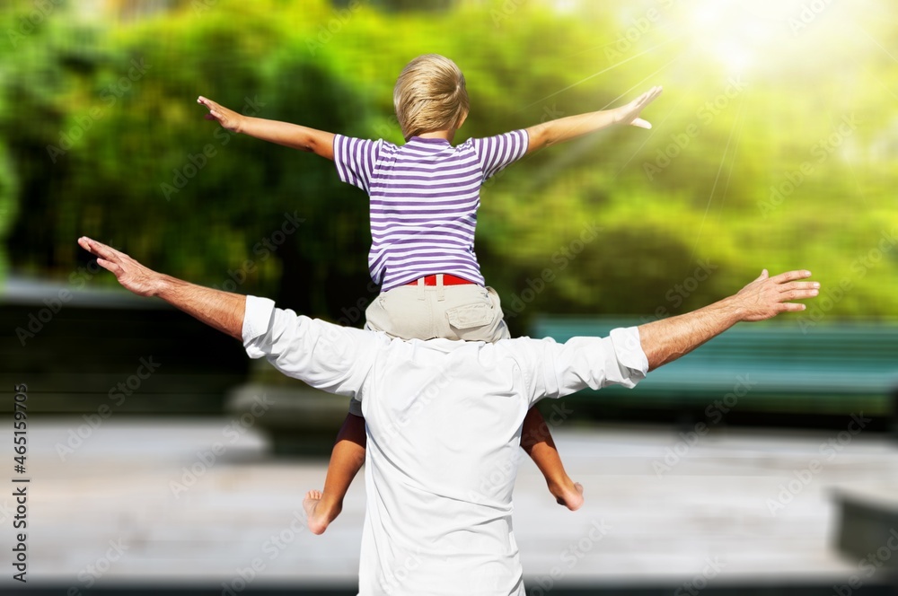 Lifestyle family father and child sat on his shoulders and run in park. Lifestyle family father and child sat on his shoulders and run in park.