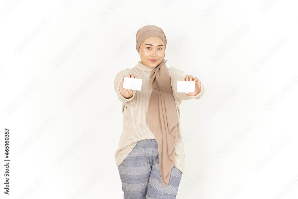 Holding and showing blank credit card of Beautiful Asian Woman Wearing Hijab Isolated On White Background Holding and showing blank credit card of Beautiful Asian Woman Wearing Hijab Isolated On White Background