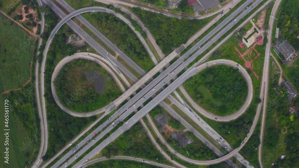 Aerial view of highway junctions with roundabout. Bridge roads shape circle in structure of architecture and transportation concept. Top view. Urban city, Bangkok at sunset, Thailand Aerial view of highway junctions with roundabout. Bridge roads shape circle in structure of architecture and transportation concept. Top view. Urban city, Bangkok at sunset, Thailand