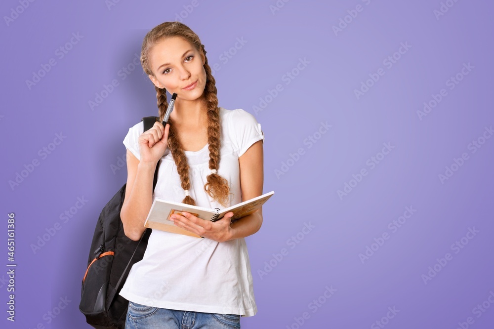 Portrait of an intelligent female student taking notes, studying, preparing for exam Portrait of an intelligent female student taking notes, studying, preparing for exam