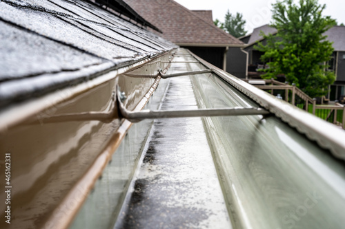 Canvastavla Selective focus on a section of residential guttering with hanger conveying water during a storm