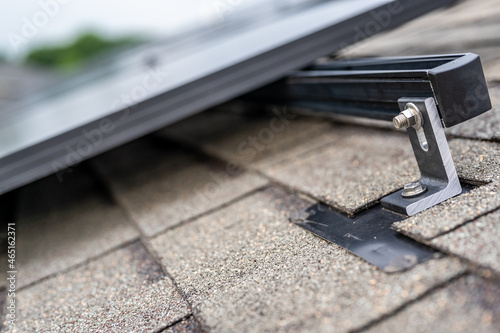 Rail, bracket, and anchor to a solar panel installed on a asphalt shingle roof