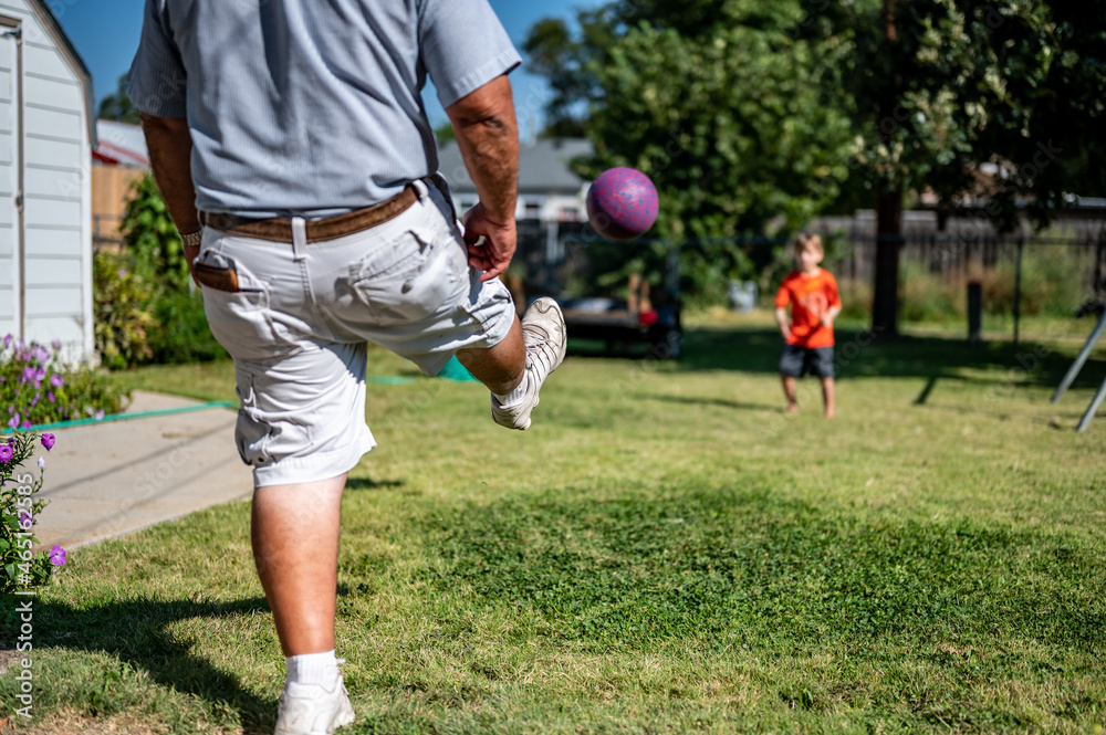 Playing kickball with grandpa in the backyard Stock Photo Adobe Stock
