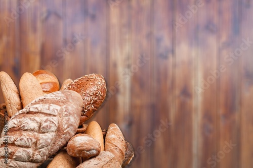 Fresh loaves of bread with wheat and gluten on a table