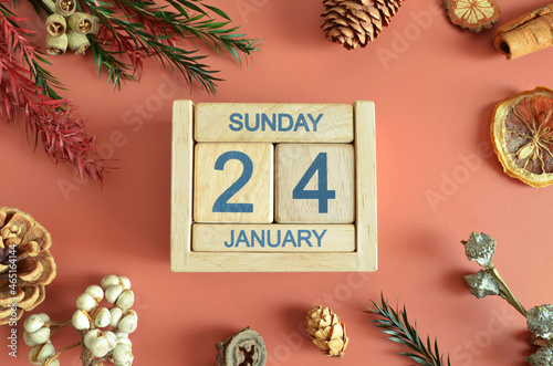 January 24, Cover design with calendar cube, pine cones and dried fruit in the natural concept.	
