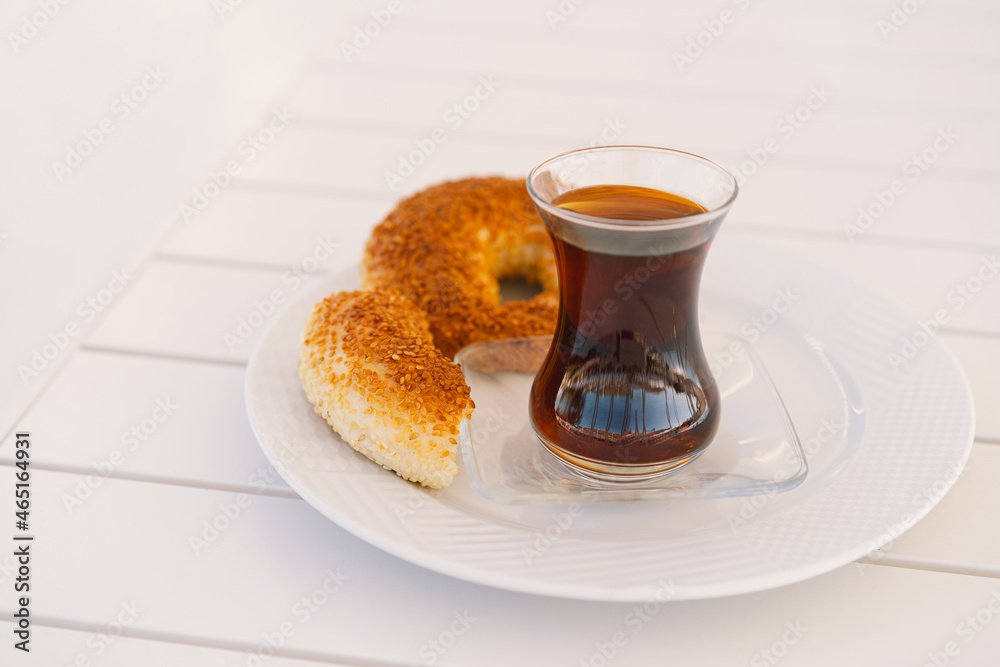 Crispy Turkish traditional bagel, simit with sesame and glass of ...