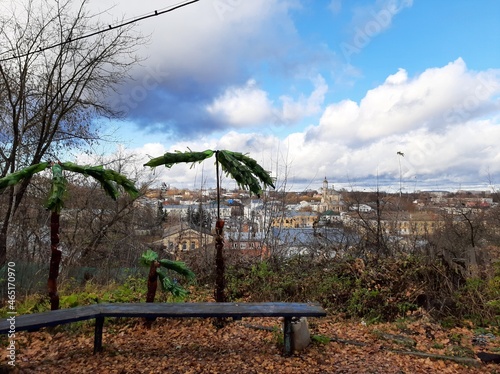 Palm trees made of plastic bottles on the background of the city