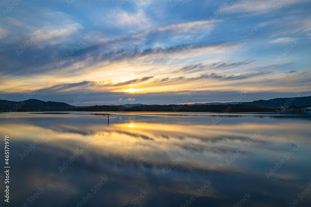Fototapeta premium Sunrise and cloud reflections waterscape