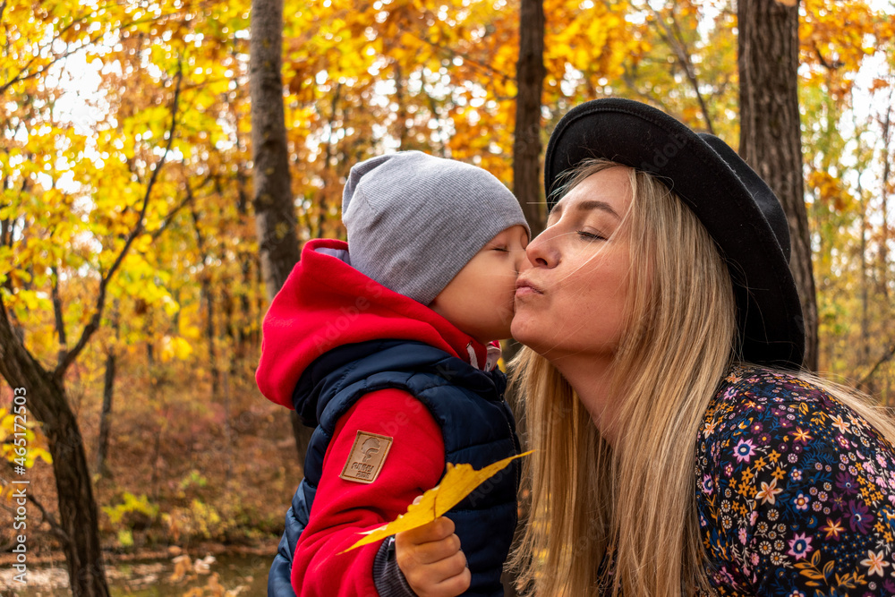 Fototapeta premium Mom and son are playing outdoors in the forest. Concept family pastime.
