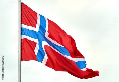 The flag of Norway hangs on the flagpole