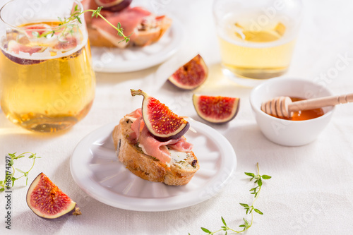 Small canape snack, crostini with ham, fig and apple wine