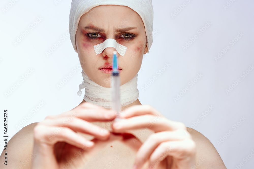 a person with bandaged face bruises syringe in hand painkillers studio lifestyle