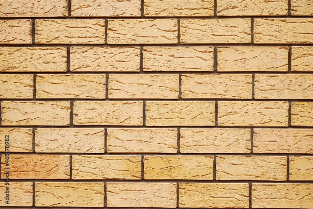 Fototapeta premium The texture of a yellow brick wall. Beautiful pattern background