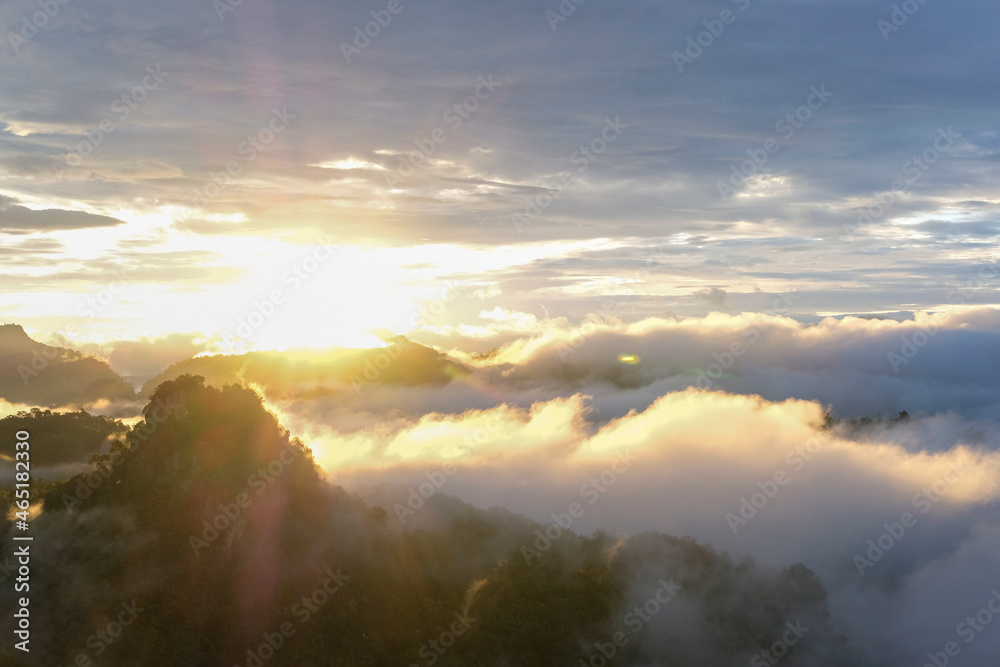 Beautiful mountain sunrise with sunlight and fog over northern Thailand's mountains