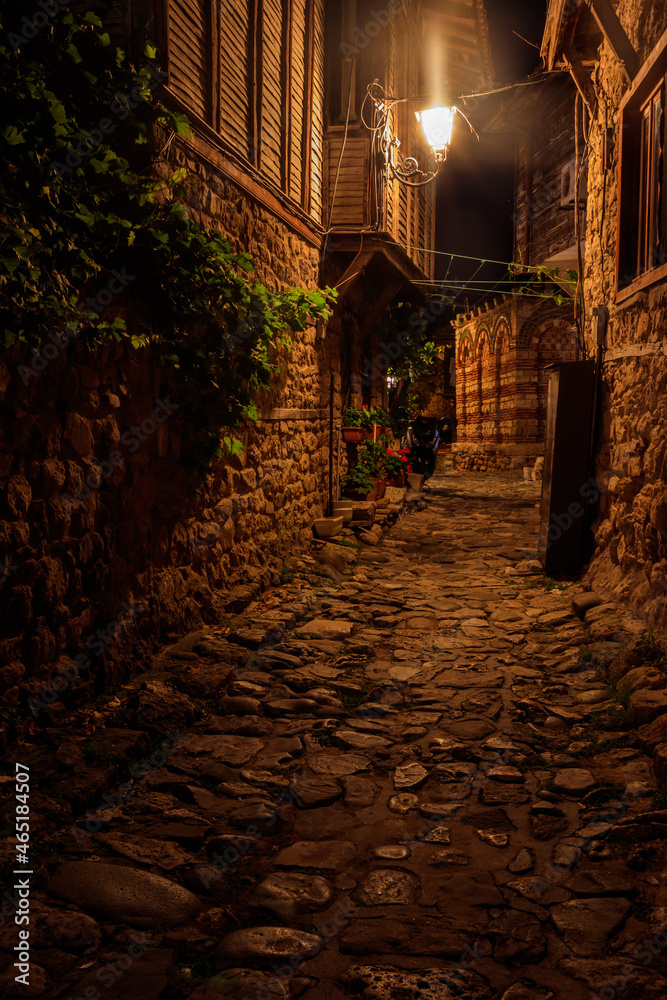 Narrow street of old town of Nessebar in Bulgaria at night